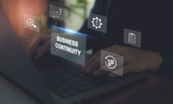 Hands typing on a laptop with a Business Continuity box, utilizing Elevate Technology and Elevation Technology risk management for cloud-based phone system, Cloud PBX Phone System, Voicemail-to-email, and Hosted PBX.