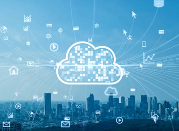 A large, pixelated cloud icon is centered in the image, with multiple thin lines radiating outward to various smaller icons. The small icons represent diverse technologies, including a home, a car, a mobile phone, a data chart, and a shopping cart. The background shows a futuristic cityscape under a light blue sky.