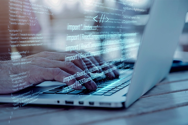  A developer's hands typing on a laptop with an overlay of code, highlighting software development, programming, and coding.