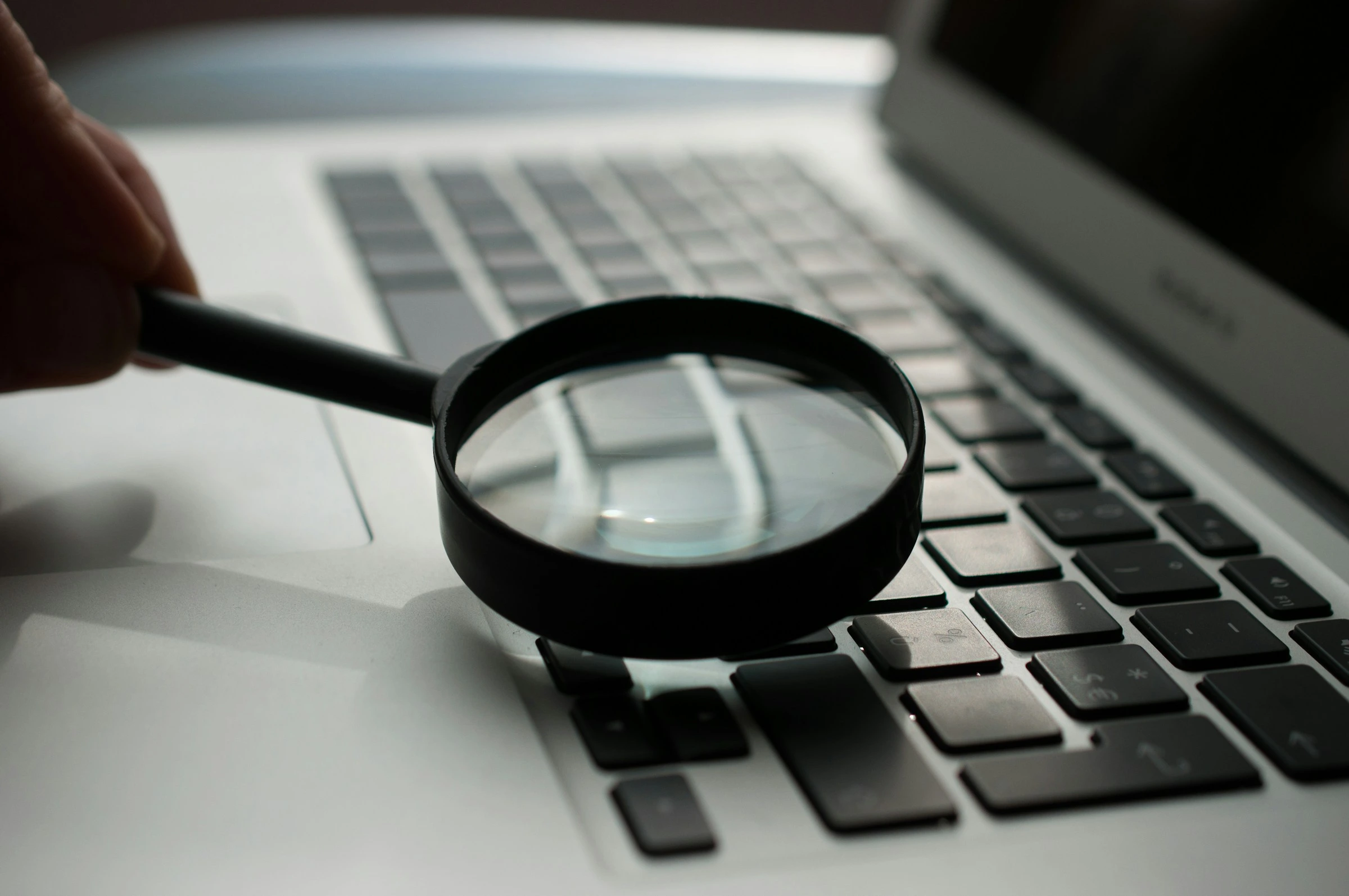 Houston business owner performing monthly IT health check on laptop at modern office desk
