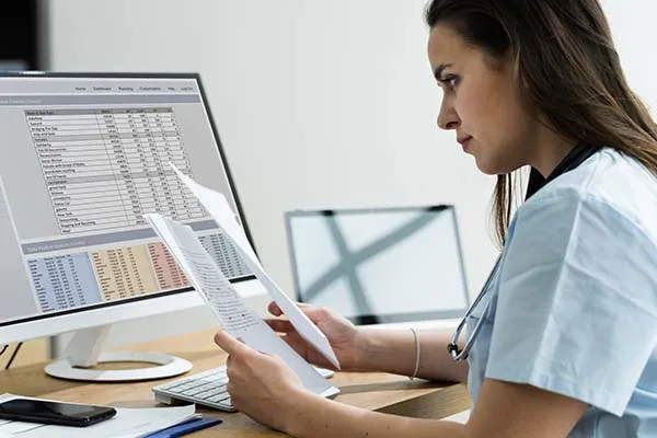 Office workstation with documents and computer, representing secure business technology solutions for healthcare and legal environments.