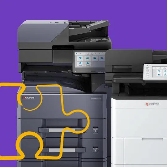 Stack of Kyocera multi‑function printers with Elevate Technology branding, representing scalable managed print solutions.