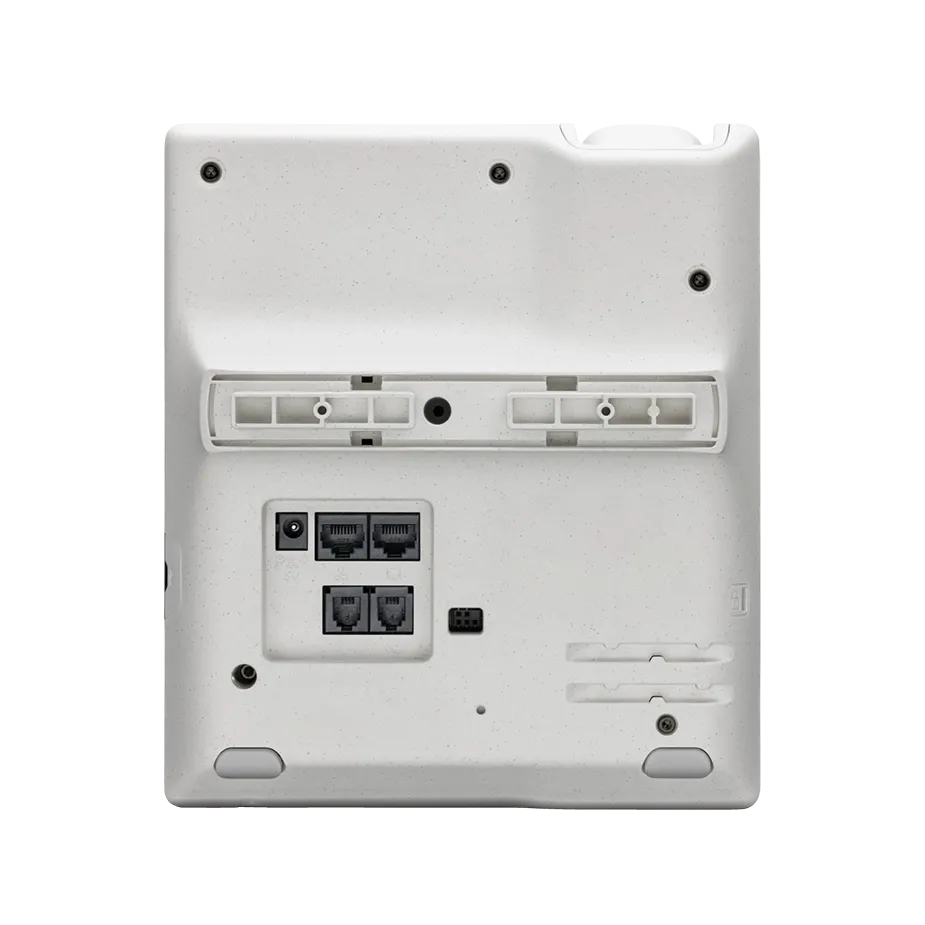 : Doctor using a desk phone while working on a laptop in a clinic, demonstrating how Elevate UC for Healthcare empowers patient-centered communication.