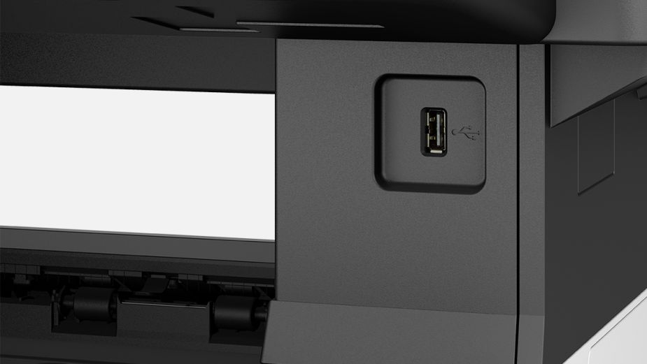 A close-up shot of the USB port on the front of a black Kyocera printer.