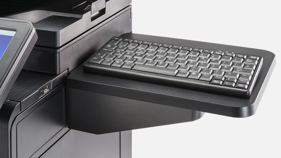 A black Kyocera DT-5100 keyboard accessory attached to the side of a printer.