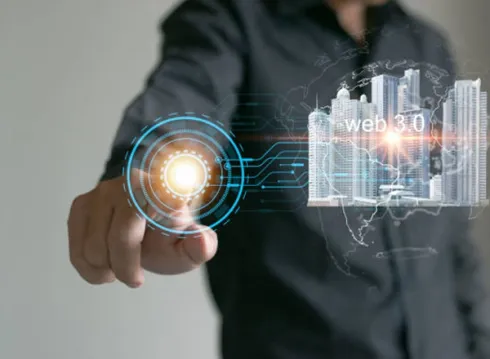A person's hand interacting with a glowing futuristic interface, symbolizing Web 3.0.