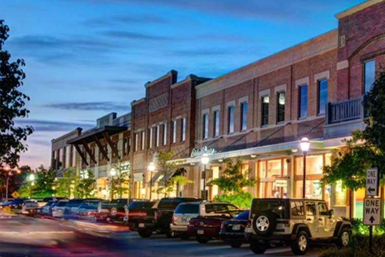 Evening view of downtown Katy, Texas with shops and parked cars, representing Elevate Technology’s local IT support, cybersecurity, and managed services for businesses in Katy.