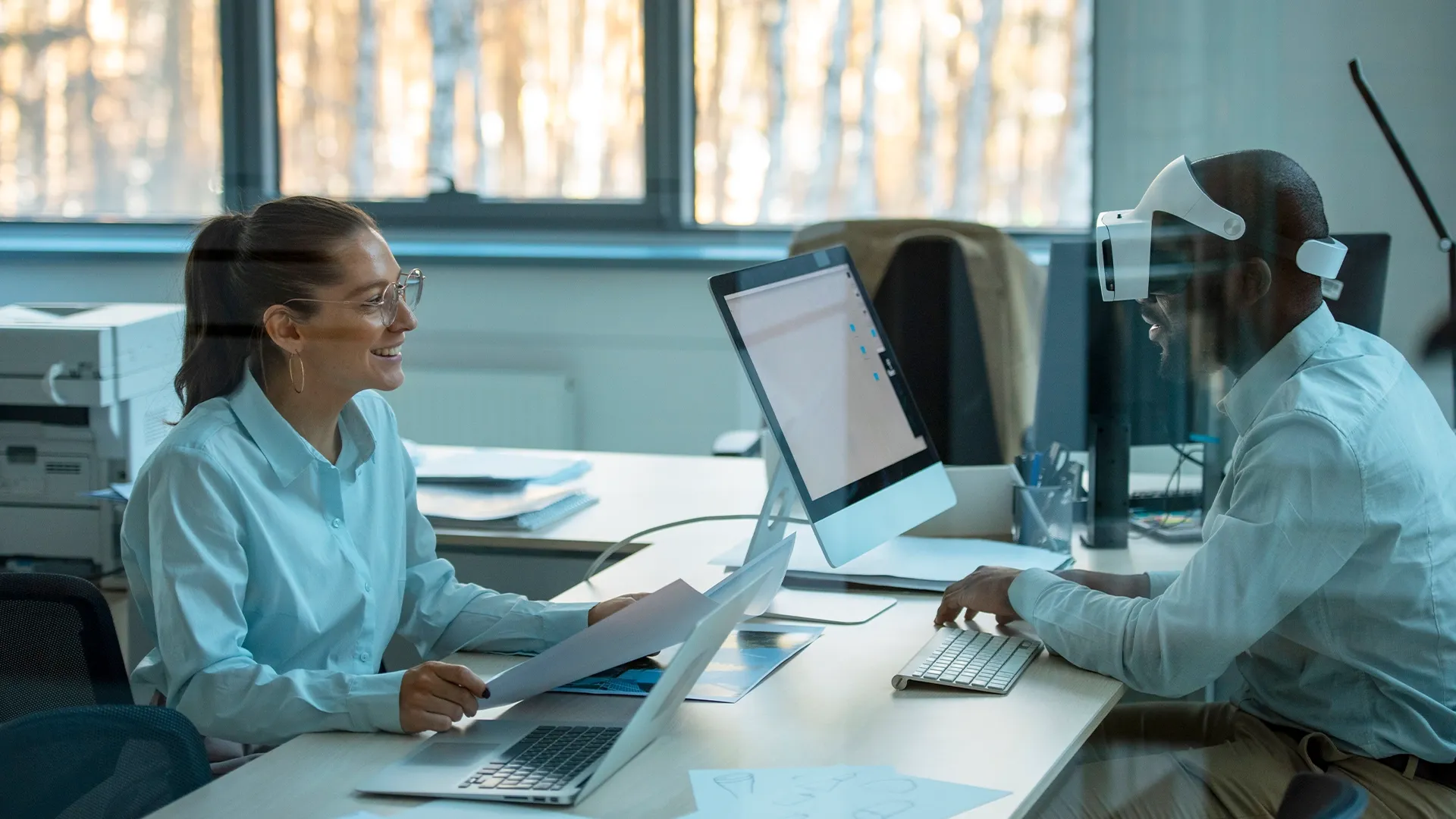 Financial advisor discussing virtual reality data with a colleague, illustrating the future of client consultation and secure Elevation Technology.